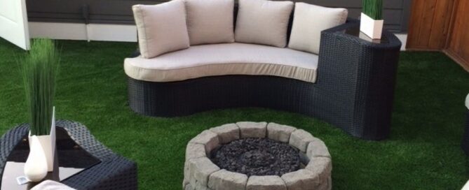 Heavy lawn furniture and fire pit sitting on top of artificial grass