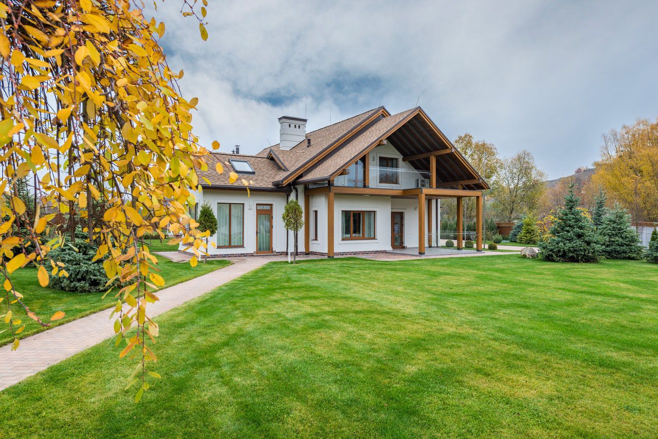 House with a large lawn during the winter fall season